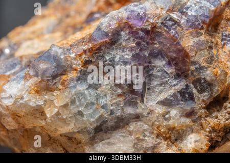 Diese Szene zeigt ein großes Gesteinsfragment mit Quarz- und Fluoritkristallen. Reflexionen und Farben von Mineralien erregen Aufmerksamkeit in der natürlichen Umgebung. Stockfoto