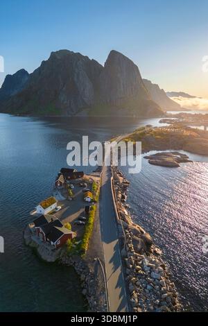 Aus der Vogelperspektive auf die Insel Hamnoya und den Berg Lilandstinden in reiner Bay während des Sommeraufgangs bei Mitternachtssonne. Lofoten-Inseln, Norwegen. Stockfoto