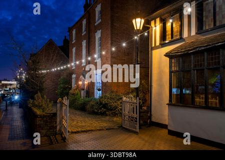 Weihnachtsdekoration vor dem Pfarrhaus entlang der Butter Street in der Abenddämmerung im dezember. Alcester, Warwickshire, England Stockfoto