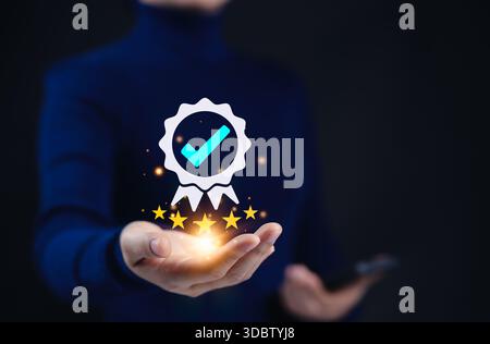 Konzept für zertifizierte Qualitätssicherung und Zertifizierung der Compliance. Eine Person hält ein leuchtendes Zertifizierungssymbol mit Häkchen und fünf goldenen Sternen Stockfoto