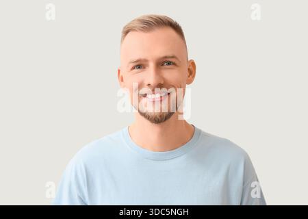 Glücklicher junger Mann auf hellem Hintergrund, Nahaufnahme Stockfoto