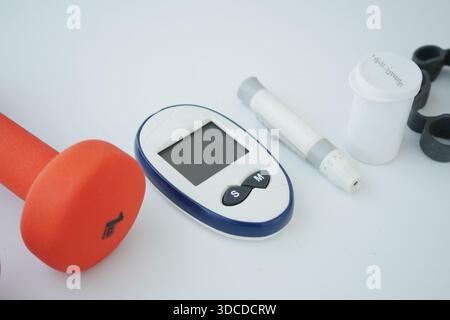 Gesundheitswerkzeuge auf weißer Oberfläche für Fitness und Monitoring Stockfoto