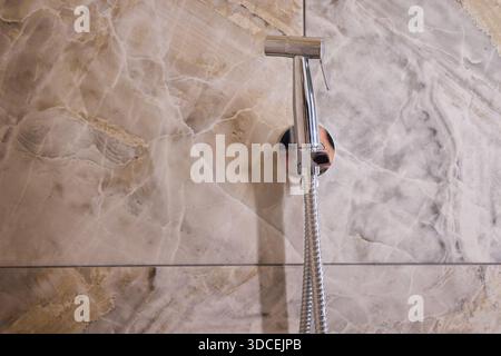 Eine elegante und stilvolle Duschhalterung mit modernem Design auf einer Marmorwand Stockfoto