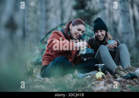 Zwei Freunde zelten zusammen, kochen einen Topf und genießen eine ruhige Wanderung im Freien Stockfoto