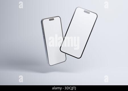 Schwebendes Modell zweier moderner Smartphones mit leeren Bildschirmen, isoliert auf hellem Hintergrund, ideal für die Präsentation mobiler Apps, UI-Design und digitaler Technologie Stockfoto