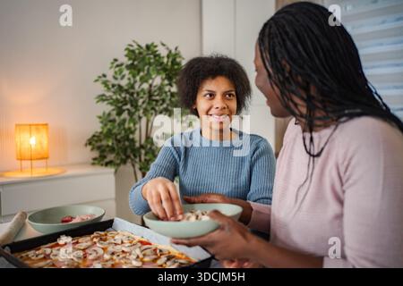 Mutter und Tochter kochen Pizza zu Hause Stockfoto