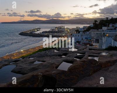 Phönizische Gräber, antike Grabstätte bei Sonnenuntergang, voller Wasser mit Blick über die Medina (Altstadt) und den Hafen in Tanger, Marokko. Dez 2025 Stockfoto