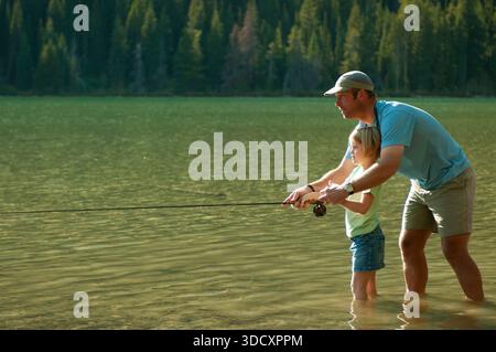 Ein Vater fischt mit seiner Tochter im Grand Teton National Park, Jackson Hole, Wyoming. Stockfoto