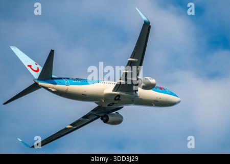 Brüssel, Belgien - 21. Dezember 2025: TUI Boeing 737-800 Passagierjet startet vom Flughafen Brüssel, von unten gesehen mit blauem Himmel. Stockfoto