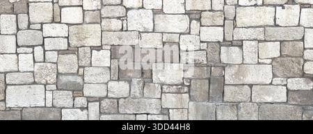 Nahaufnahme einer alten und verwitterten Steinmauer, die einen rustikalen strukturierten Hintergrund schafft Stockfoto