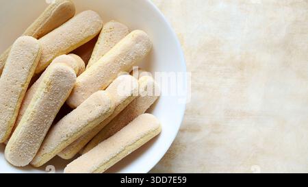 Eine Gruppe von Savoiardi-Keksen, auch bekannt als „Ladyfingers“ in einer Schüssel. Sie sind eine Zutat in Tiramisu oder charlotte. Italienisches Essen. Stockfoto