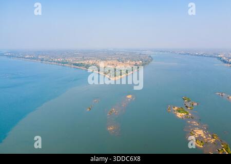 Weitläufige Luftperspektive auf den Mekong River und das Land in Stoeng Treng, Kambodscha. Das breite blaue Wasser, die Sandbänke und die verstreuten Inseln schaffen eine ruhige Flusslandschaft unter klarem Himmel. Stockfoto
