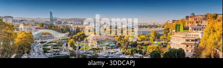 31. Oktober 2025, Tiflis, Georgien: Stadtlandschaft mit Herbstbäumen, zeitgenössischer Architektur und dem Fluss Kura Stockfoto