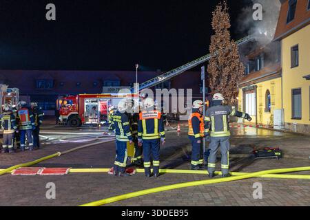 Lieferwagen brennt neben Gebäude Feuer greift auf Dachstuhl über am 31.12.2025 geriet kurz vor 02:00 Uhr ein Lieferwagen in Brand, der direkt neben einem Gebäude mit Wohn- und Geschäftseinheiten in Bickenbach Stand. Die Flammen griffen auf den angrenzenden Dachstuhl über und breiteten sich auf dem Großteil des Dachbodens aus. Da dieser nicht von innen erreichbar war, müssen die Einsatzkräfte die gesamten Dachziegel entfernen, um gezielte Löschmaßnahmen durchführen zu können. Vier Drehleitern sowie ein Mast der Werkfeuerwehr Merck kam zum Einsatz. Winterliche Minusgrade erschwerten die Lösc Stockfoto