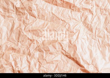 Zerknitterte, hellbeige Papierstruktur mit natürlichen Falten und weichen Schatten. Hintergrund. Stockfoto