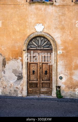 Hölzerne Tür eines Wohngebäudes im historischen Zentrum von Volterra, einer toskanischen Hügellandschaft, bekannt für ihre mittelalterlichen Straßen, Volterra, Toskana Italien Stockfoto