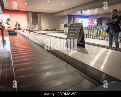 NIZZA, FRANKREICH - 26. SEPTEMBER 2025: Gepäckausgabebereich an einem Flughafen mit einem Warnschild vor nicht lizenzierten Taxis mit einem Edelstahlband in nic Stockfoto