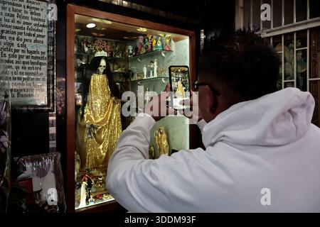 Tausende von Gläubigen von Santa Muerte strömen in das Viertel Tepito im Stadtteil Cuauhtémoc von Mexiko-Stadt, um das neue Jahr 2026 zu beginnen, indem sie sich bedanken und die „Weiße Dame“ bitten, sie vor allem Bösen zu schützen und ihnen Gesundheit, Wohlstand und Beschäftigung zu gewähren. Dieser Altar ist der wichtigste im Land, weil er der erste war, der öffentlich zugänglich gemacht wurde. Der Besitzer und Beschützer dieses Altars ist Enriqueta Romero, besser bekannt als "Doña Queta". Der mexikanische glaube an den Tod hat prähispanische Wurzeln und stammt nicht aus Gefängnissen oder Drogenhandel, wie oft angenommen wird. Aber diese Hingabe hat es getan Stockfoto