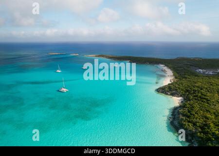Aus der Vogelperspektive auf Segelboote, die in türkisfarbenem Wasser in der Nähe der Insel ankern Stockfoto