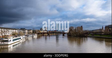 Blick auf die Frankfurter Skyline und die Eiserner Steg über den Main unter einem dramatischen stürmischen Himmel. Stockfoto