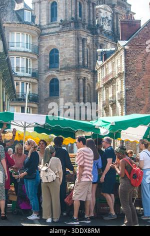 Morgensonnenlicht über dem Place des Lices Sonntagsmarkt mit der Kathedrale Saint-Pierre und historischen Fachwerkhäusern in Rennes, Bretagne, Frankreich Stockfoto