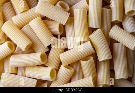 Nahaufnahme von rustikalen, ungekochten italienischen Rigatoni-Nudeln Stockfoto