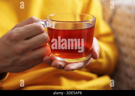 Mann mit einer Tasse heißem Tee drinnen, Nahaufnahme Stockfoto