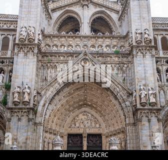 Detaillierte Ansicht der komplizierten Steinschnitzereien und religiösen Statuen an der Fassade der historischen Kathedrale von Toledo in Spanien. Stockfoto