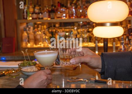 Die Leute toasten mit Margarita und Whisky an einer Bar Stockfoto