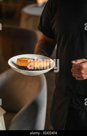 Gegrilltes Lachsfilet, serviert vom Koch auf Teller Stockfoto