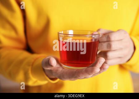 Mann mit einer Tasse heißem Tee drinnen, Nahaufnahme Stockfoto