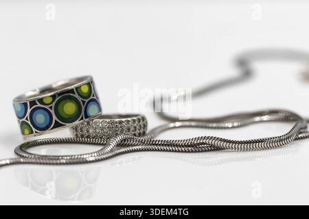 Elegante Silberkette mit Schlangengewebe und Silberringen mit Zirkonia und farbiger Emaille Stockfoto