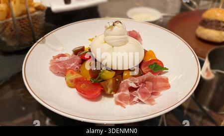Buratta-Käse-Tomaten-Salat, serviert in einem gehobenen Restaurant Stockfoto
