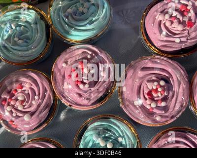 Verdrehte Zuckerguss-Desserts in Tassen, süße Leckereien, Konzept der Bäckerei, Süßwaren, Party Stockfoto