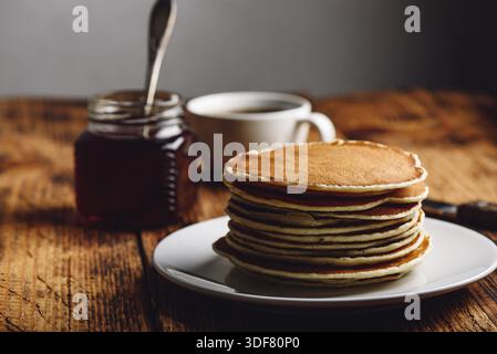 Stapel Pfannkuchen am weißen Platte über Holz- Oberfläche Stockfoto