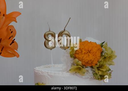 Kuchen mit 80 Kerzen-Nummer-Topper Stockfoto