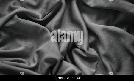 Ein schwarz-weißer Hintergrund aus zerknittertem Stoff. Nahaufnahme. Stockfoto