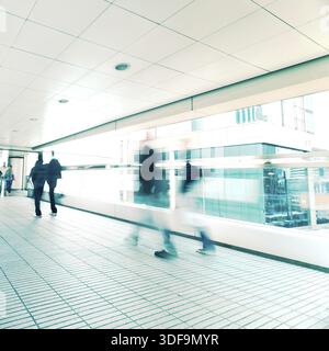 Abstrakter Stadthintergrund. Verschwommenes Bild von Menschen, die sich in einem Tunnel auf überfüllten Straßen bewegen. Hongkong. Unschärfeeffekt, Farbton im Vintage-Stil Stockfoto