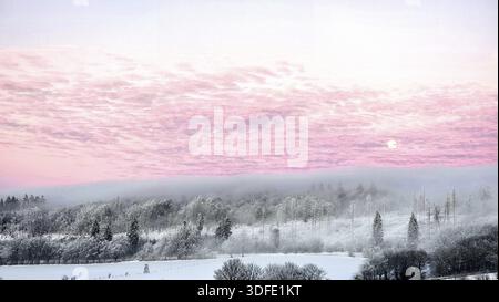 Schneebedeckte Landschaft bei Sonnenuntergang mit rosa Himmel und frostbedeckten Bäumen. Dämmerung, der Mond scheint durch den Nebel. Volle Mondaufgangsatmosphäre mit untergehender Sonne Stockfoto