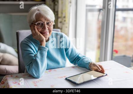 Ältere Frau mit digital-Tablette zu Hause Stockfoto