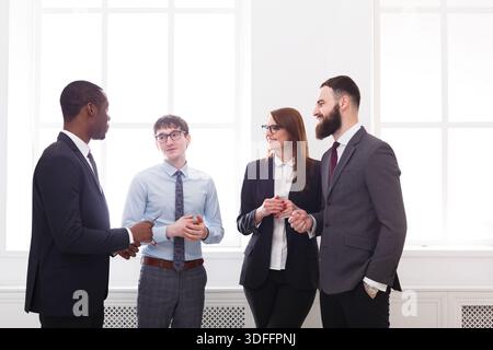 Multiethnisches Firmentreffen erfolgreicher Manager in formeller Kleidung im Büro, Geschäftsleute mit Kopierraum Stockfoto