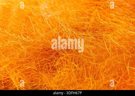 Nahaufnahme mit orangefarbener Filzstruktur aus Wolle Stockfoto