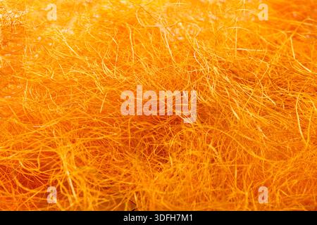 Nahaufnahme mit orangefarbener Filzstruktur aus Wolle Stockfoto