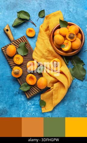 Eule von Reifen Aprikosen und Holzbrett auf blauem Grunge-Hintergrund. Verschiedene Farbmuster Stockfoto