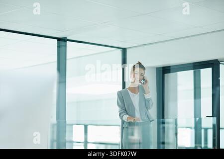 Lächeln, Telefonanruf oder Geschäftsfrau im Flur, Kundenberatung oder Börsenanlagegespräch. Sprechen Sie, Portfolio-Feedback oder Investor auf Mobilgeräten für Stockfoto