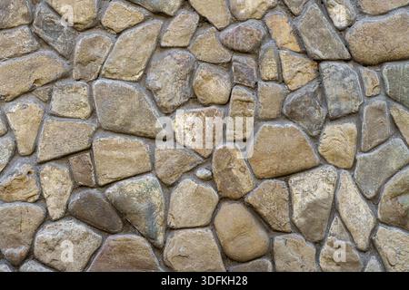 Natursteinmauer. Abstrakter natürlicher Hintergrund. Stockfoto