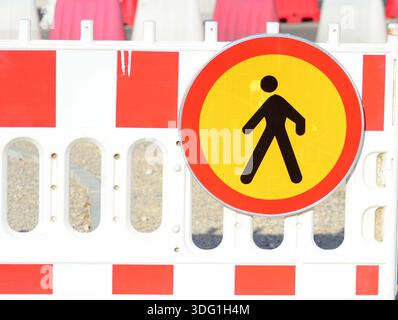 Rot-gelbes, abgerundetes Verkehrsschild warnt Fußgänger vor einem verbotenen Wegebereich zum Gehen Stockfoto