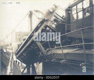 Zugentgleisung: Forest Hills Wrack, 5. Dezember 1921. Boston, Massachusetts. Das Foto vom Dach neben dem Zugwagen zeigt die Rückseite des Autos, die an erhöhten Bahngleisen hängt. Stockfoto
