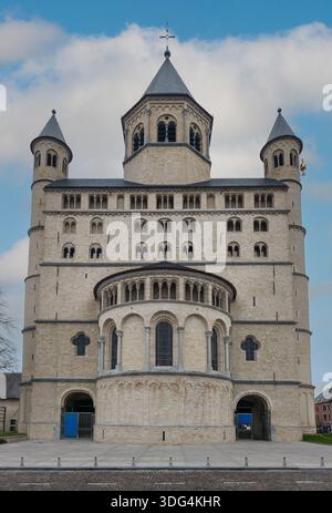 Beeindruckender Außenblick auf die historische Stiftskirche Saint Gertrude von Nivelles mit romanischer Steinarchitektur, Türmen und offenem Platz Stockfoto