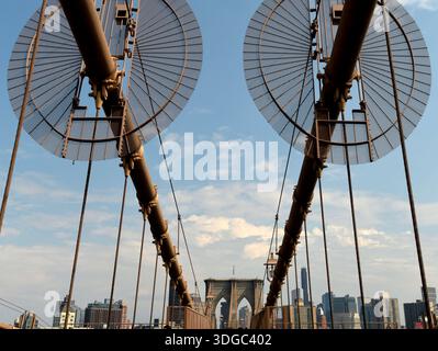 Die 1883 erbaute Brooklyn Bridge ist die erste Hängebrücke aus Stahl und überblickt die Wolkenkratzer von Manhattan, den Big Apple. Stockfoto